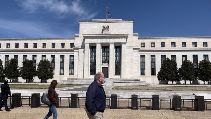 People walk past the Federal Reserve building on March 19, 2021 in Washington, DC.