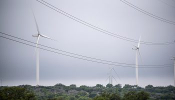 Blades from a wind turbine rotate in a field, April 16, 2021 near Eldorado, Texas.