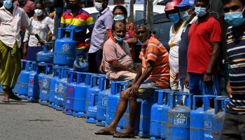 People queue to buy Liquefied Petroleum Gas (LPG) cylinders following shortages of essentials, in Colombo on March 14, 2022. (Photo by Ishara S. KODIKARA / AFP) (Photo by ISHARA S. KODIKARA/AFP via Getty Images)