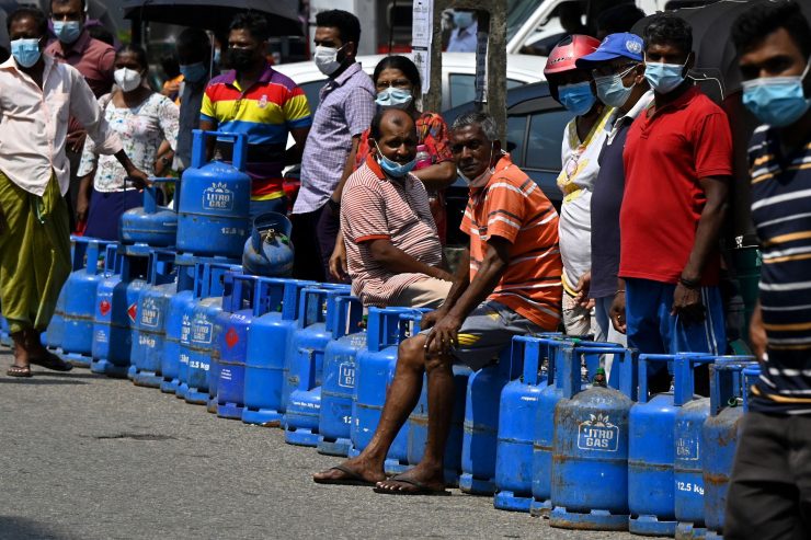 People queue to buy Liquefied Petroleum Gas (LPG) cylinders following shortages of essentials, in Colombo on March 14, 2022. (Photo by Ishara S. KODIKARA / AFP) (Photo by ISHARA S. KODIKARA/AFP via Getty Images)