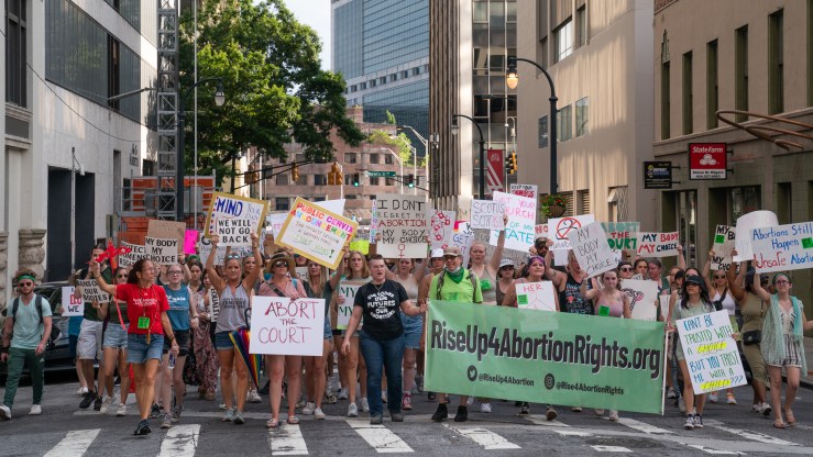 People march in the street during a protest against the Supreme Court's ruling in the Dobbs v Jackson Women's Health Organization on June 25, 2022 in Atlanta, Georgia.