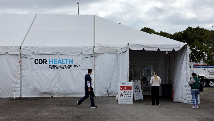 People walk into a tent for a free monoclonal antibody treatment in Miami.