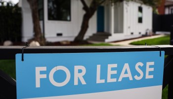 A "For Lease" sign outside a house.