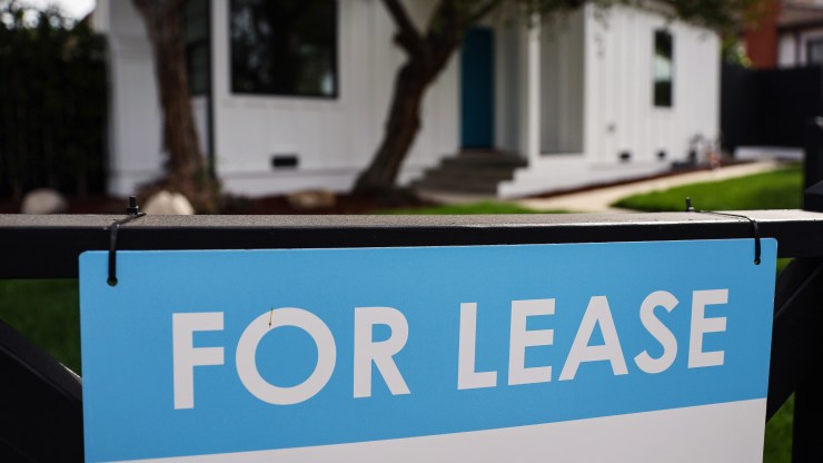 A "For Lease" sign outside a house.