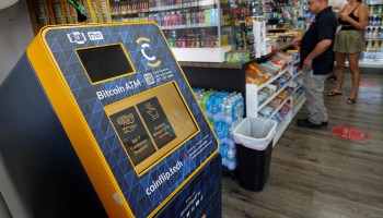 A cryptocurrency ATM at a checkout counter at a Miami shop.