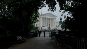 The Supreme Court is seen behind trees.