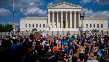 Protesters stand in front of the Supreme Court.
