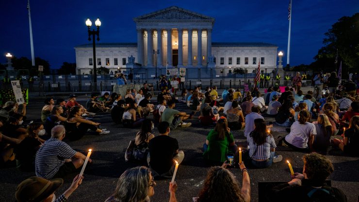 Protesters attend a candlelight vigil in front of the U.S. Supreme Court to denounce the court's decision to end federal abortion rights protections.