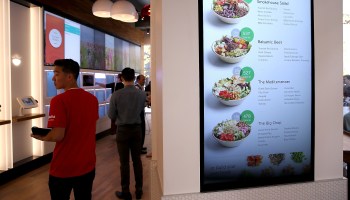 A menu and customers at a fully automated fast food restaurant in San Francisco in 2015.