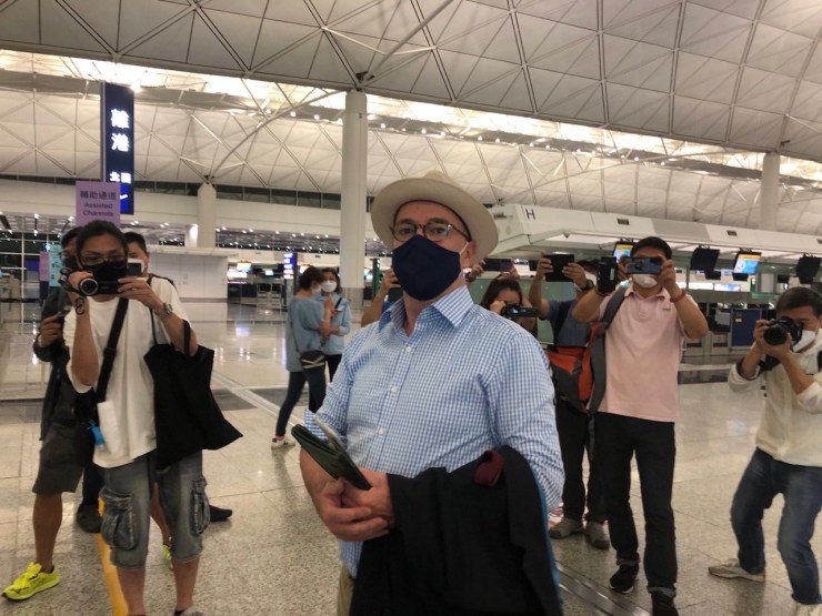 Michael Vidler at the Hong Kong airport in April 2022 surrounded by reporters, some from pro-Beijing media, grilling him about why he's leaving Hong Kong in such a hurry. (Courtesy Michael Vidler)