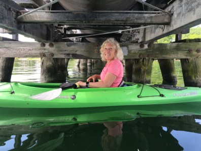 Kim Holtzman takes a break on her green kayak in Seneca Lake, underneath Greenidge's large tube. 
