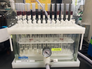 Vials of smoke-tainted red wine undergo the first stages of smoke analysis in a laboratory machine. 