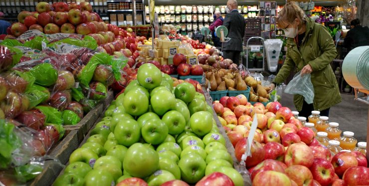 Rows of red and green apples at a supermarket.