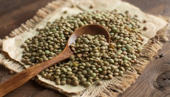 A view of lentils atop a wooden table. Hundreds of consumers say they've gotten ill after consuming a Daily Harvest product containing lentils and leeks.