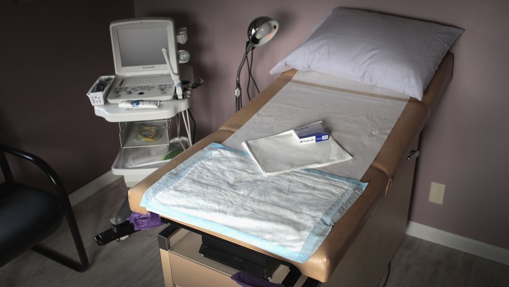 An ultrasound machine sits next to an exam table in an examination room at Whole Woman's Health of South Bend in South Bend, Indiana.