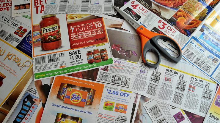 A pile of coupons and a pair of scissors.