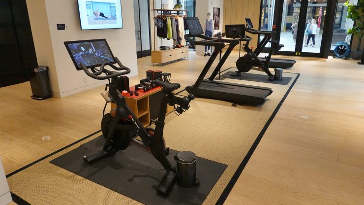 The interior of a Peloton store with a row of Peloton workout equipment.