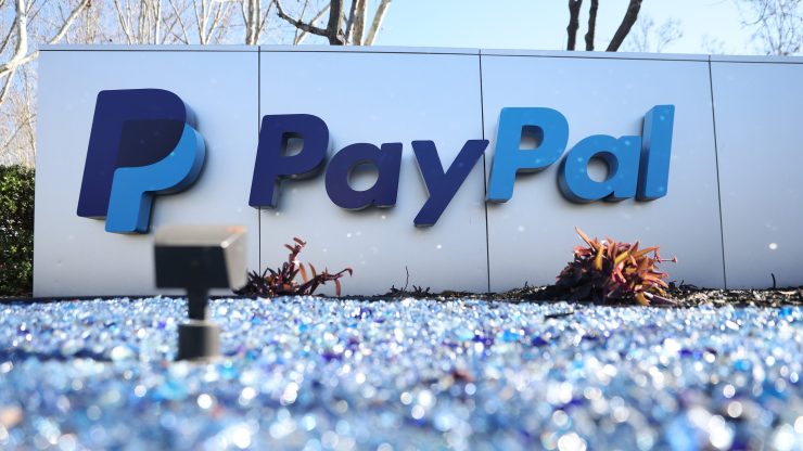 A white sign with the blue PayPal logo outside the PayPal headquarters.