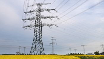 Electricity pylons stand over a field of rapeseed on May 10, 2022 near Berlin, Germany.