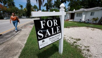 A For Sale sign hangs in front of a home in Miami