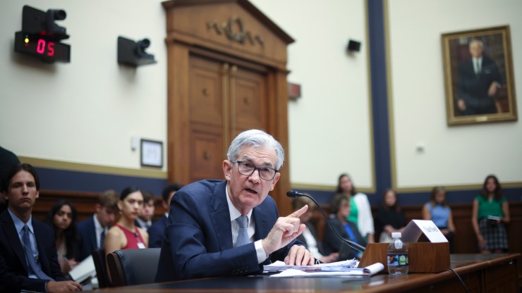 Jerome Powell, chairman of the Board of Governors of the Federal Reserve, points his index finger and speaks into a microphone at a House Committee meeting.