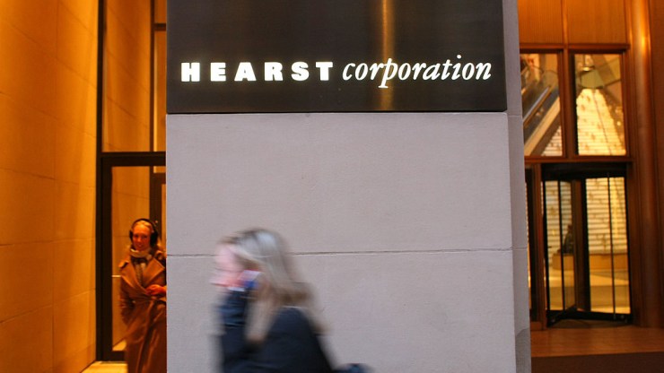 A pedestrian passes by the Hearst building in New York City.