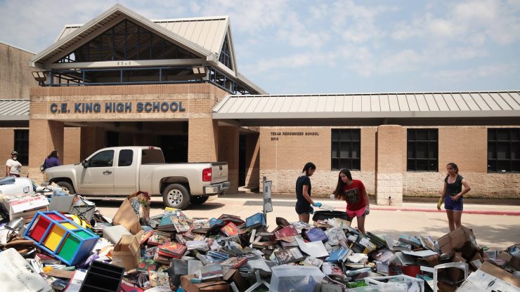 A school in Texas that flooded after Hurricane Harvey. Damaged school supplies and furniture are piled outside the entrance.