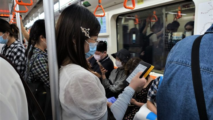 A subway commuter in Shanghai reading on a Kindle device in July 2022.