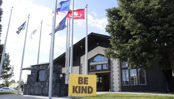 A "Be Kind" sign is posted at the West Yellowstone visitor's center
