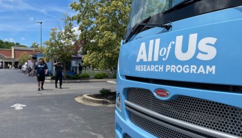 The front of a blue bus reads "All of Us Research Program."