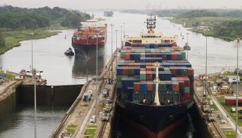 Freighters enter the Panama Canal on the Atlantic side.
