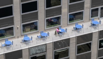 A person eats lunch on the terrace of a Manhattan office building.
