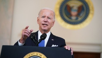 US President Joe Biden addresses the nation behind a podium
