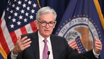 Federal Reserve Chair Jerome Powell is seen speaking at a lectern.