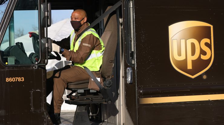 A UPS driver in a delivery truck.