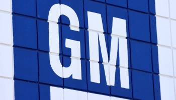 The General Motors logo painted on a brick wall.