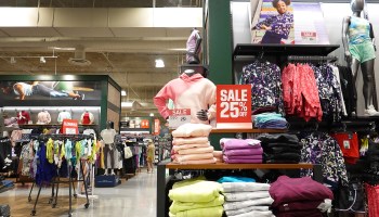 A sale sign sits on a display of sweatshirts at a Dick's Sporting Goods store.