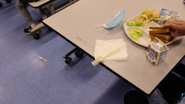 A student eats a vegan meal with milk for lunch at a New York City school.