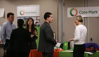 Job-seekers meet with recruiters at a hiring fair.
