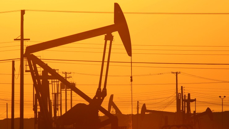 Fracking pump jacks at dawn in an oil field.