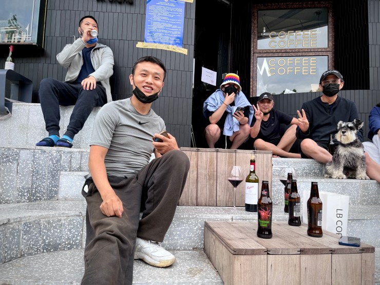 Chef Li Hongji having a drink and laugh with friends when officials slightly eased what had been a particularly harsh lockdown in Shanghai in May 2022. He was let go by his employer about two weeks prior. (Jennifer Pak/Marketplace)
