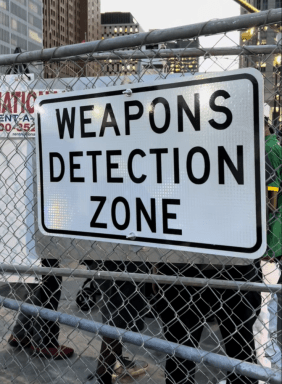 The Detroit Police Department fenced off Hart Plaza, requiring attendees to walk through an Evolv Technology weapons detection gate checkpoint.