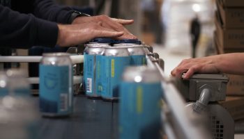 Fresh cans of beer come off the production line at Athletic Brewing’s non-alcoholic brewery and production plant on March 20, 2019 in Stratford, Connecticut.