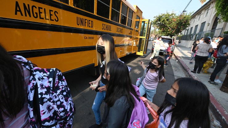Students and parents arrive masked for the first day of the term at a Los Angeles school.