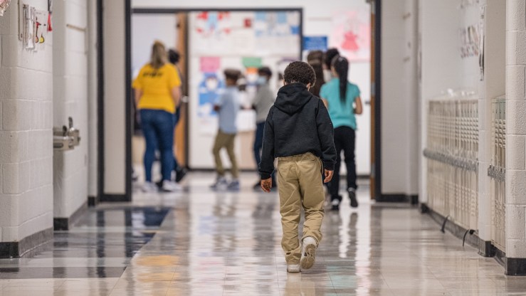 A young boy walks down a hallway at Carter Traditional Elementary School in January in Louisville, Kentucky.