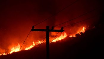 The Fairview Fire burns behind power lines near Hemet, California on September 6, 2022.