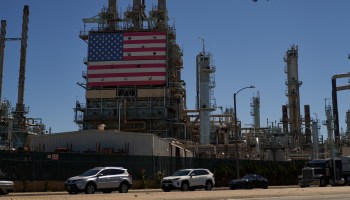 An oil refinery displays an American flag.