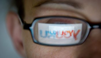 The logo of Chinese video-sharing website Youku is reflected in a pair of glasses.