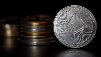 An ethereum coin arranged standing up on its side.