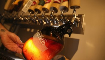 A growler of beer is getting filled at a brewery in Miami, Florida.